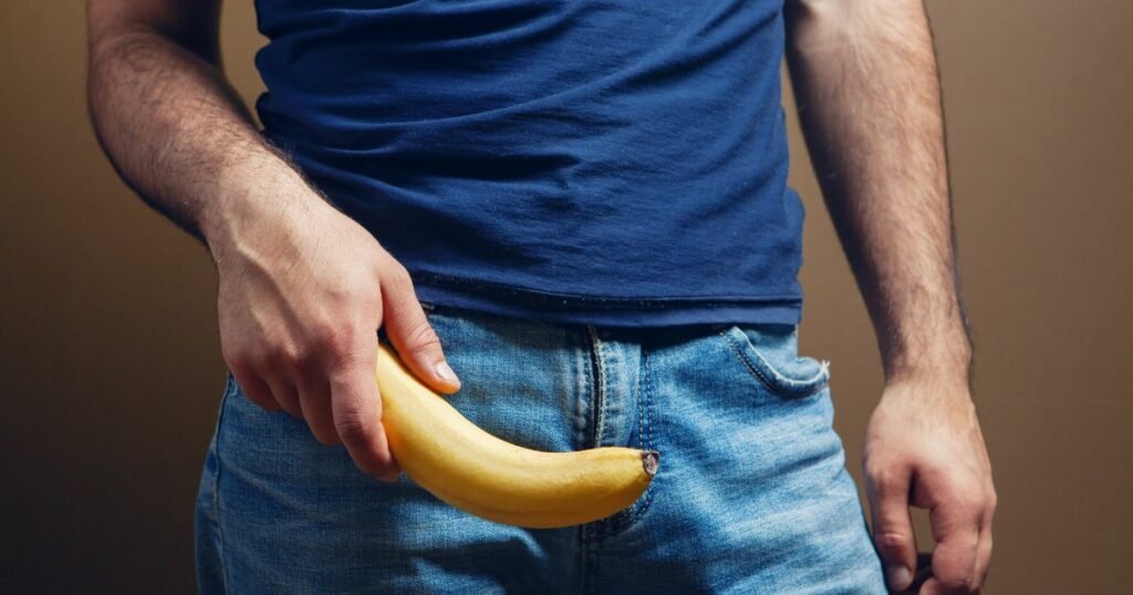 man holding a banana showing masturbation