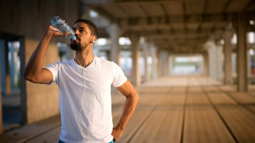 A man drinking water to show hydration