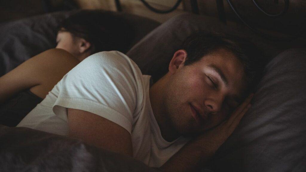 a man sleeping beside a woman